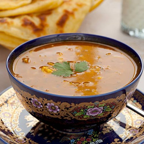 cup of moroccan harira soup served in traditional bowl with msemen